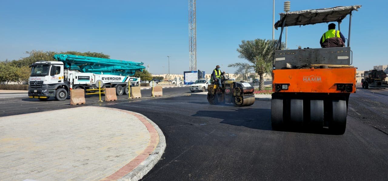 Concrete pump and roller working a street junction